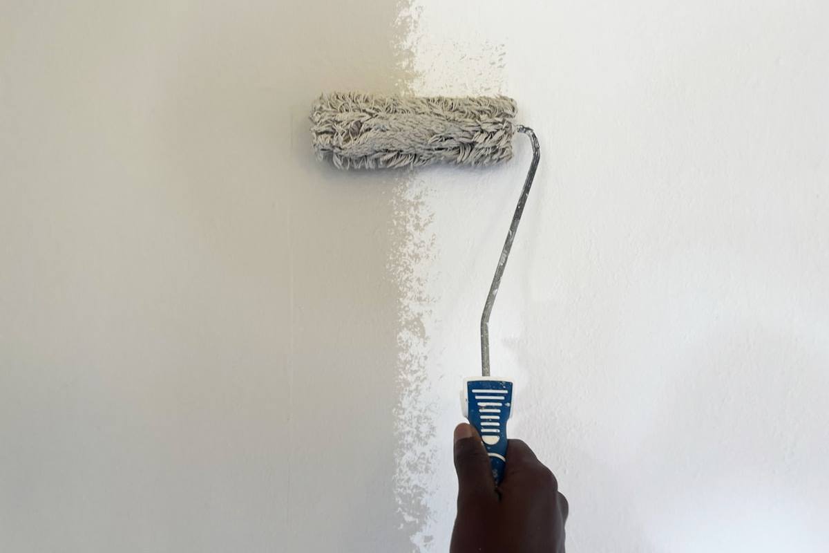 Rolling fresh paint onto an interior wall